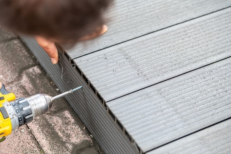 a deck builder in Canberra installing composite decking
