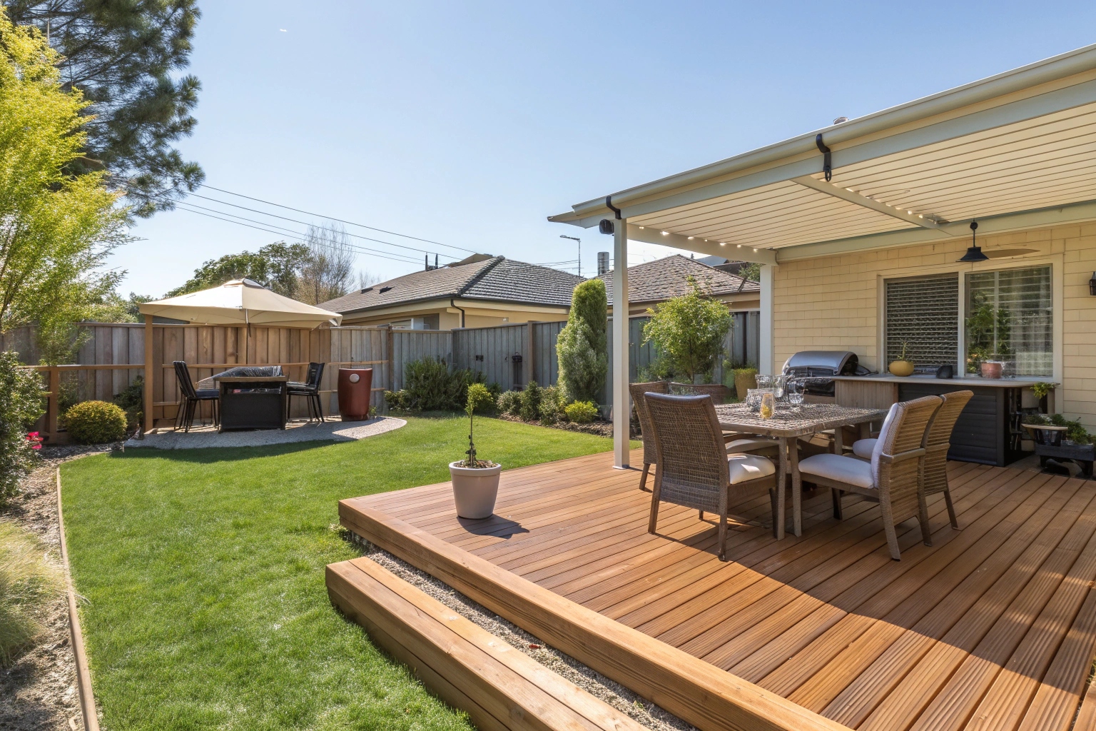 Treated pine decking Canberra backyard with outdoor furniture and BBQ area